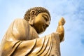 Statue of Buddha with raised hands reaching skyward