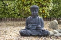 Statue of Buddha sitting in lotus position Royalty Free Stock Photo