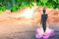 Statue Buddha standing on leaf lotus and bodhi with ocean and sun Royalty Free Stock Photo
