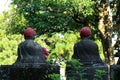 The statue of a Buddha using a hat ? in a public cemetery comp Royalty Free Stock Photo