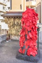 Statue of the Buddhist deity Akagami Nio covered with red papers deposited by the faithful to purify and heal the sick parts