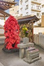 Statue of the Buddhist deity Akagami Nio covered with red papers deposited by the faithful to purify