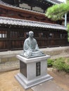 Statue of buddhist monk sitting in lotus pose Royalty Free Stock Photo