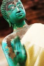 statue of Budha focused on face and with blurry hand Royalty Free Stock Photo