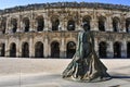 statue of bullfighter Nimeno II and Roman amphitheater in Nimes, France Royalty Free Stock Photo