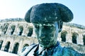 statue of bullfighter Nimeno II and Roman amphitheatre in Nimes, France Royalty Free Stock Photo