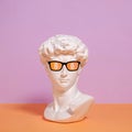 Statue of a bust of Roman David in sunglasses and a symbol of bitcoin.