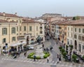 Statue of Camillo Benso Conte di Cavour with people walking around seen from aerial perspective.