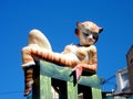 Statue of a cat in the form of a woman under a clear blue sky in Valencia, Spain