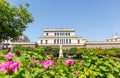 Statue of Charilaos Trikoupis in front of Old Parliament, Athens, Greece. Nature surrounds the white sculpture. Blue sky