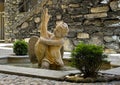 Statue of a cherub with a large waterfowl in a small fountain at the entrance to Villa Cipressi in Varenna on Lake Como.