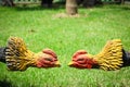 Statue chicken (fighting cock) on grass in temple Thailand. Royalty Free Stock Photo