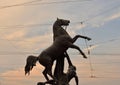 Statue of the conquest of a horse at sunset.