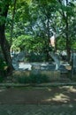 Statue in the corner of the garden made of cast cement Royalty Free Stock Photo