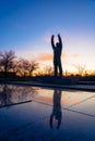 Statue of cosmonaut Yuri Gargarin with raised hands at Gagarin park at sunset