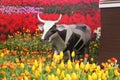 Statue of cow with tulips