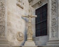 Statue of a cross outside the facade of the Seville Town Hall facing the Plaza de San Francisco.