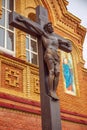 Statue of the crucified Christ on the cross near the wall of the Cathedral of the Life-Giving Trinity. Orenburg region Royalty Free Stock Photo