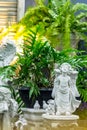 Statue of Cupid in cozy garden. Royalty Free Stock Photo