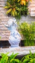 Statue of Cupid in cozy garden. Royalty Free Stock Photo