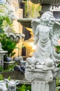 Statue of Cupid in cozy garden. Royalty Free Stock Photo