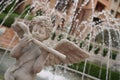 A statue of Cupid playing a flute in the middle of a fountain Royalty Free Stock Photo