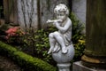 Statue of Cupid playing the flute Royalty Free Stock Photo