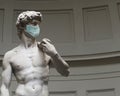 Statue of David by Michelangelo wearing a surgical mask to protect from the coronavirus Royalty Free Stock Photo