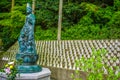 Statue depicting a Buddhist goddess keeping watch over many smaller Bhuddist statues. Munakata, Japan.