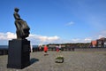 Statue depicting a fisherwoman from Urk placed on a plinth on the edge of the IJsselmeer