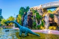 statue of a dinosaur in front of an artificial rock in the genoves park in cadiz...IMAGE