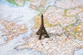 Statue of Eiffel Tower on a map, Paris most romantic tourist destination Royalty Free Stock Photo