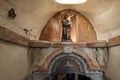 The statue of Elijas the prophet and crucified Jesus Christ stands in a niche above the entrance to the grotto of the Milk Grotto