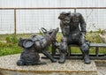 Statue of exhausted gold rush era miner and his dog in Skagway