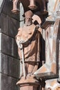 Statue on the facade of St. Nicholas Roman Catholic Cathedral constructed in the Gothic style Royalty Free Stock Photo