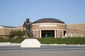 Statue of famous football player and university building