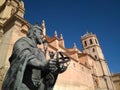 Statue of the famous Spanish medieval king called Alfonso X known as `The Wise King` , and the historical Saint Patrick Church Royalty Free Stock Photo