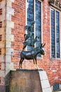 Statue of farm animals near a brick building