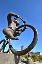 A statue featuring a monkey riding a circus bicycle