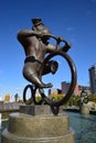 A statue featuring a monkey riding a circus bicycle