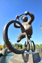 A statue featuring a monkey riding a circus bicycle