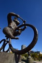 A statue featuring a monkey riding a circus bicycle