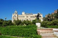 Statue of the flower seller Biznaguero in the Pedro Luis Alonso gardens with the city hall to the rear, Malaga, Spain. Royalty Free Stock Photo