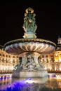 Statue fountain of three graces on the place de la bourse in Bordeaux city at night in Gironde New Aquitaine France Royalty Free Stock Photo