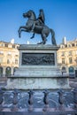 Statue of the French King Louis XIV (14th) in the center of Victories Place in Paris under a pure cold blue sky