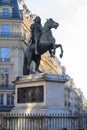 Statue of the French King Louis XIV (14th) in the center of Victories Place in Paris under a pure cold blue sky