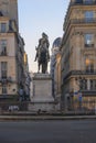 Statue of the French King Louis XIV (14th) in the center of Victories Place in Paris under a pure cold blue sky