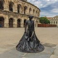 Statue of torero with the roman arena of Nimes, Southern France in background Royalty Free Stock Photo