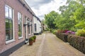 A statue in front of the old cottages in the picturesque village of Drimmelen, Netherlands Royalty Free Stock Photo