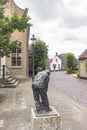 A statue in front of the old cottages in the picturesque village of Drimmelen, Netherlands Royalty Free Stock Photo
